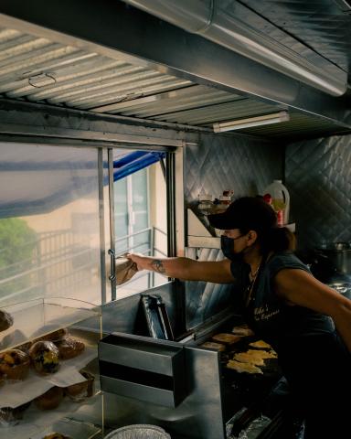 a person cooking food in a kitchen