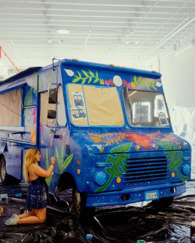 a truck cake sitting on top of a blue wall