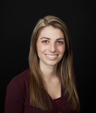 a person who is smiling and looking at the camera