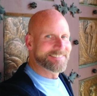 a man standing in front of a mirror posing for the camera