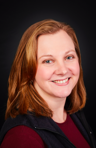 a woman who is smiling and looking at the camera
