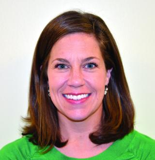 a smiling woman in a green shirt