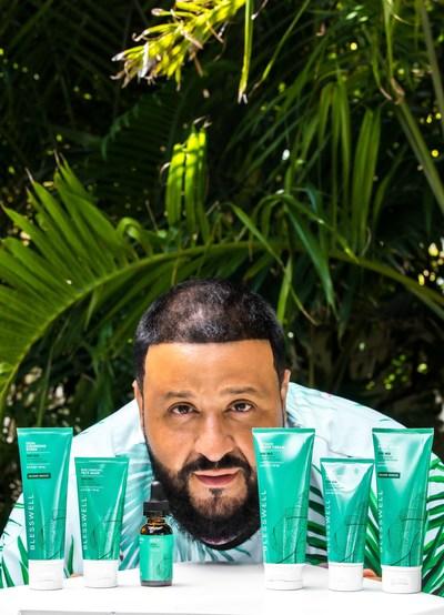 DJ Khaled standing in front of a tree