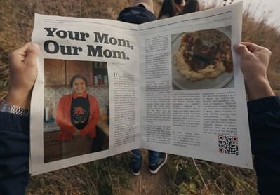 person,text,newspaper,grass,sign,box,reading,doughnut,refrigerator,holding,standing,woman,book,donut,people,display,posing,man,sitting,group,food